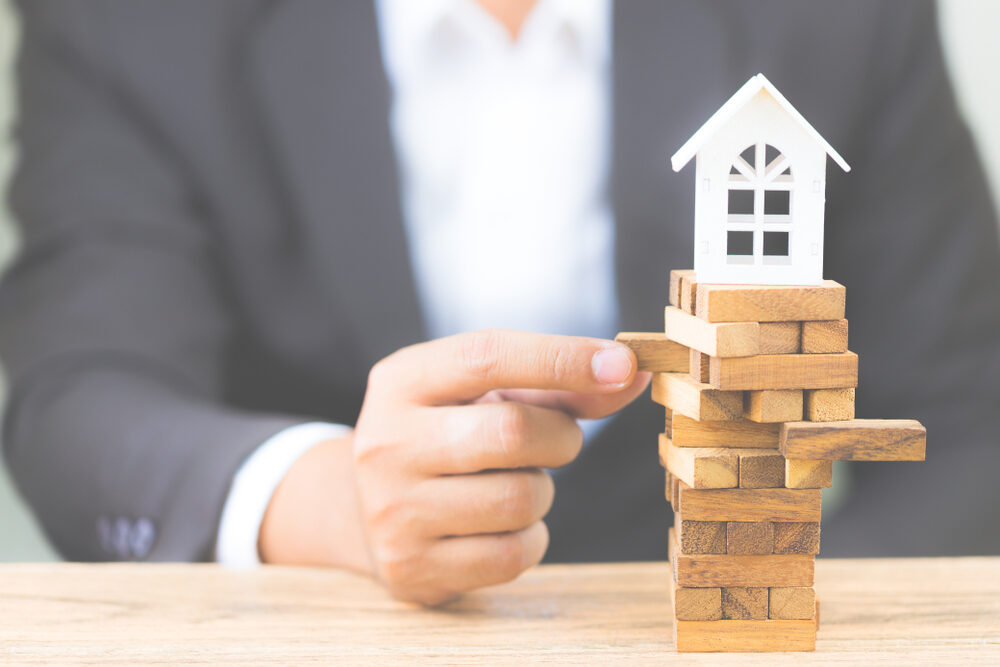 Investor weighing the pros and cons of a blanket loan for rental properties