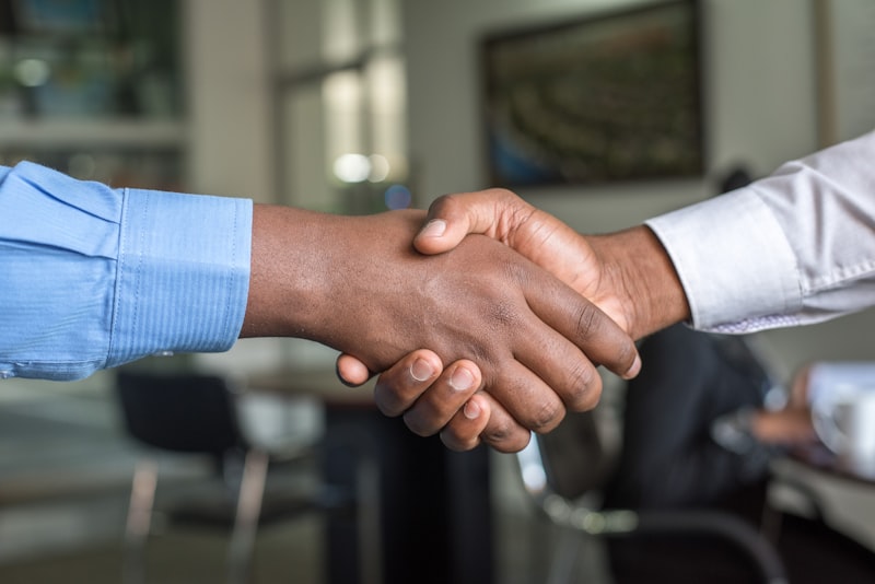 Landlord and tenant handshake after signing a rental agreement