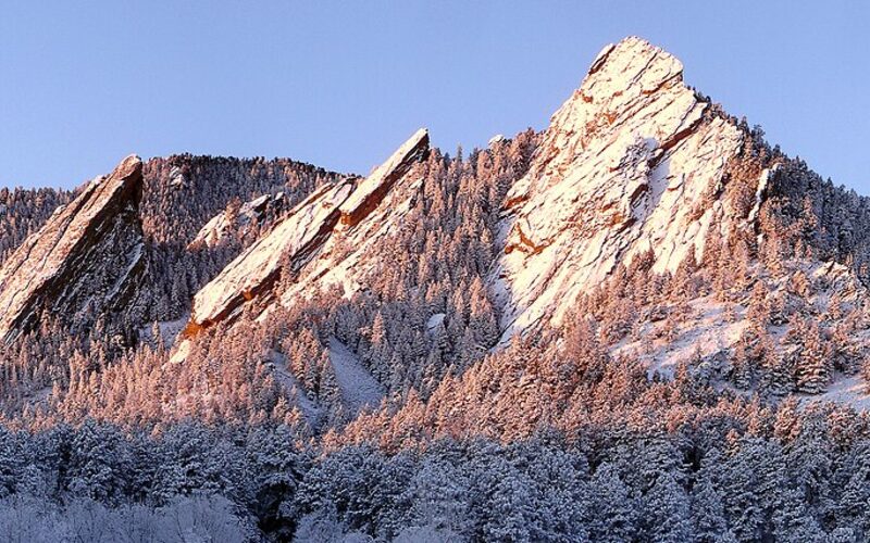 Boulder Flatirons rock formations in winter with snow