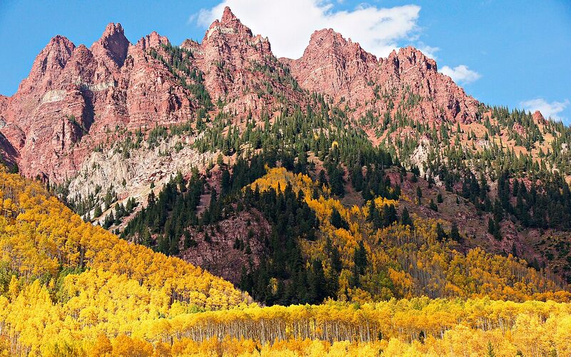 Rocky Mountain peaks in Colorado with golden aspen trees in autumn