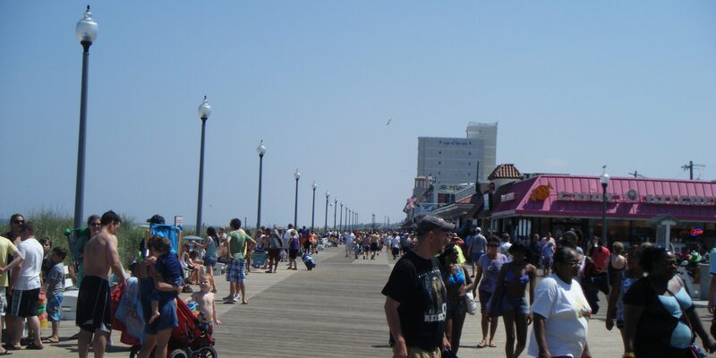 Rehoboth Beach Boardwalk with shops, restaurants, and beachgoers along the Atlantic coast