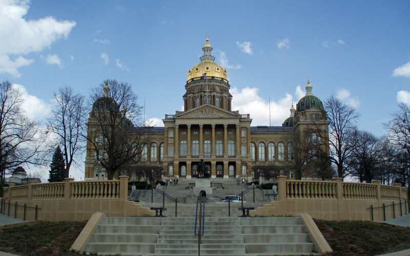 Iowa State Capitol building in Des Moines with its golden dome and grand stone staircase