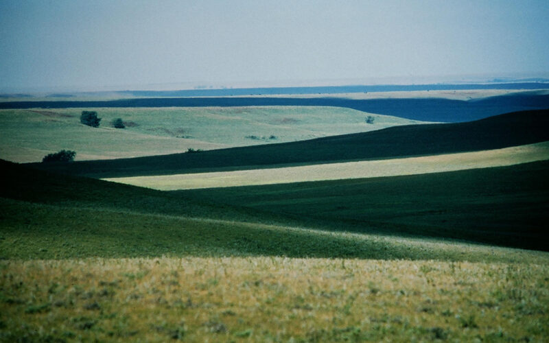 Vast tallgrass prairie rolling hills of the Flint Hills in Kansas with dramatic light and shadow