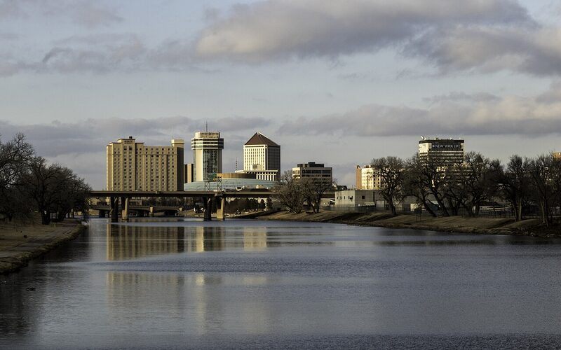 Downtown Wichita skyline along the Arkansas River at dusk