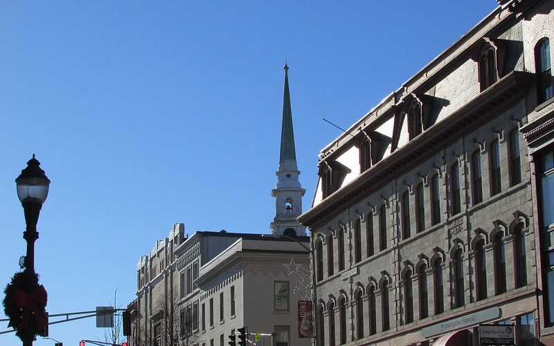 Downtown Bangor, Maine street with church steeple and historic buildings