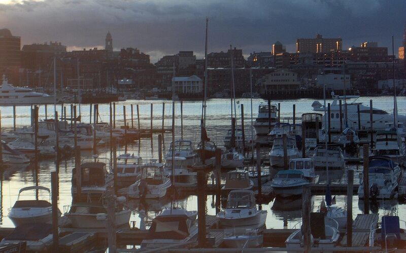 Marina at dusk with Portland skyline visible across the harbor in South Portland, Maine