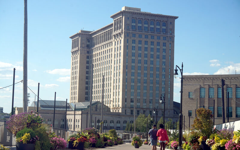 Michigan Central Station in Detroit after Ford Motor Company restoration with landscaped walkway and flower planters in the foreground