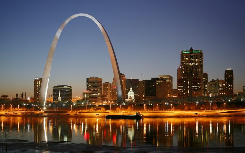 Gateway Arch and St. Louis skyline reflected in the Mississippi River at twilight