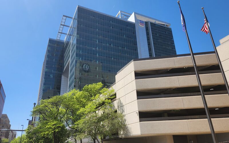 Union Pacific Center headquarters building in downtown Omaha Nebraska with the UP shield logo and American flag against a blue sky