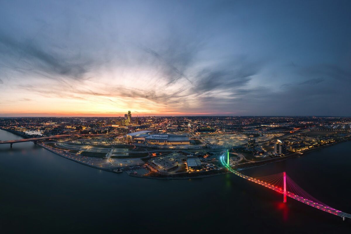 Aerial view of downtown Omaha Nebraska at sunset with the Bob Kerrey Pedestrian Bridge and Missouri River