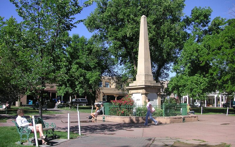 Santa Fe Historic Plaza with central obelisk monument and visitors in New Mexico