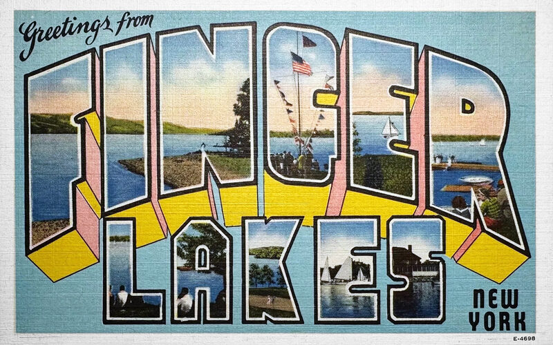 Vineyards overlooking a Finger Lakes lake in central New York with rolling green hills and blue water