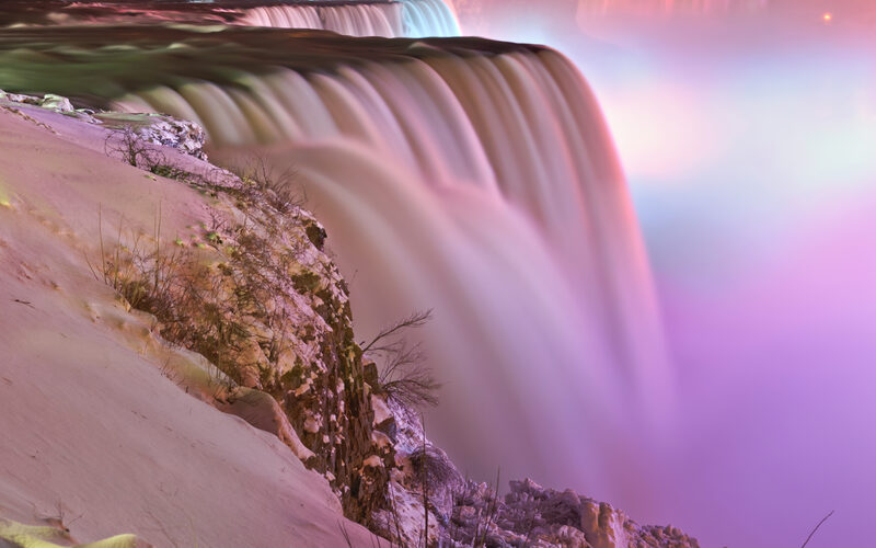 Niagara Falls with the massive Horseshoe Falls and mist rising from the gorge on the New York side