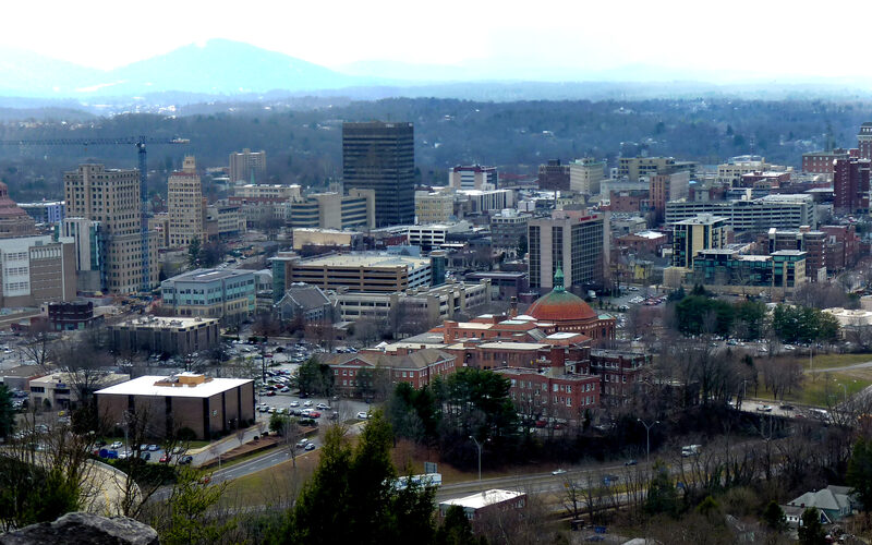 Asheville downtown with the Blue Ridge Mountains visible behind the art deco skyline