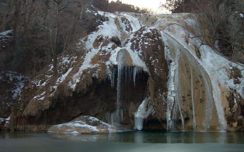 Turner Falls 77-foot waterfall and natural swimming pool in the Arbuckle Mountains of Oklahoma