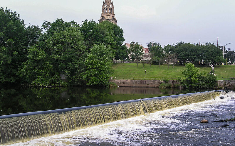 Waterfall and dam along the Blackstone River with church steeple in Pawtucket, Rhode Island