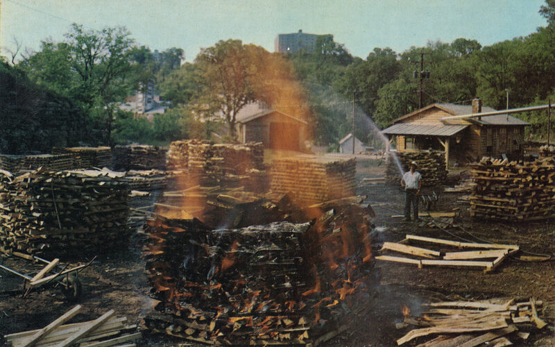 Historical photograph of the charcoal mellowing process at Jack Daniel's in Lynchburg, Tennessee