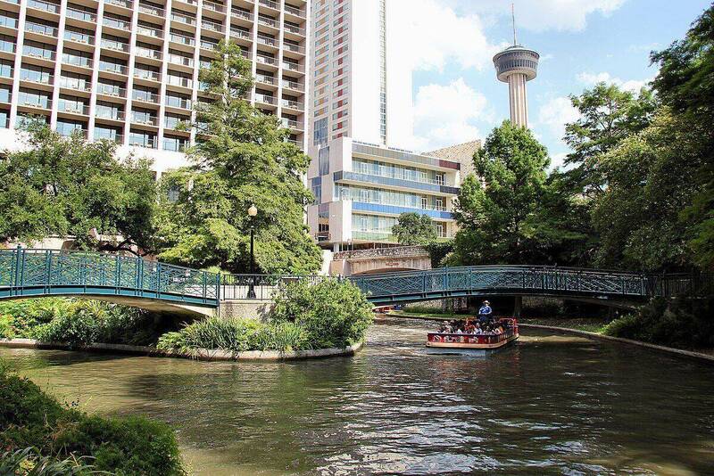 San Antonio River Walk with colorful umbrellas and restaurants