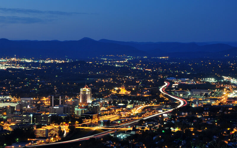 Roanoke skyline nestled in the Blue Ridge Mountains with the iconic Roanoke Star visible on Mill Mountain