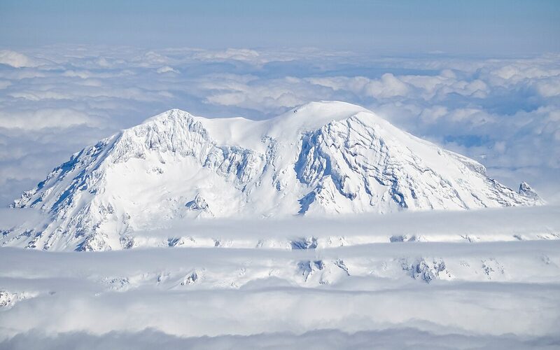 Snow-capped Mount Rainier rising above the clouds in Washington State