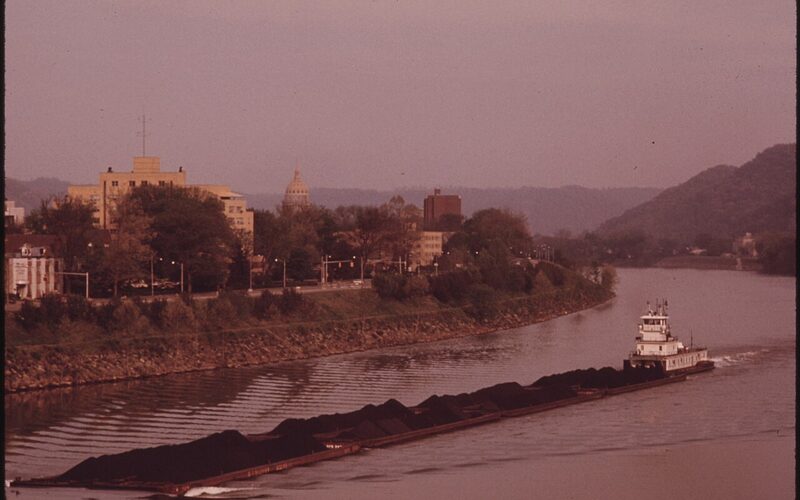 Coal barge on the Kanawha River with the Charleston, West Virginia skyline in the distance