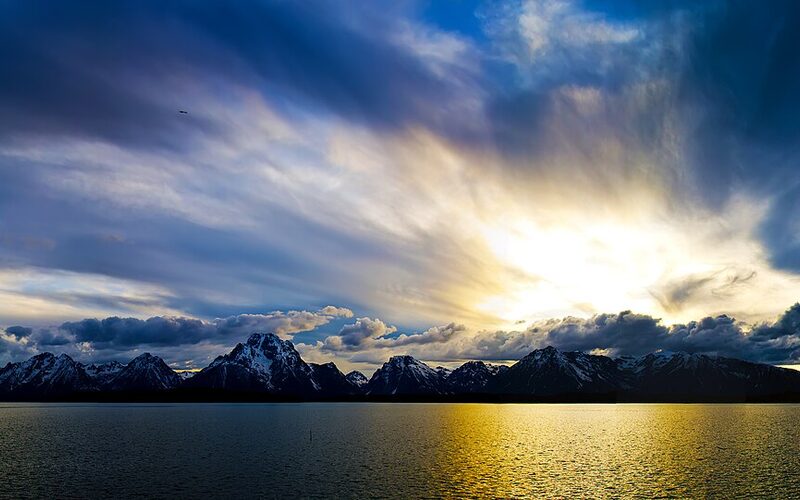Grand Teton mountain range reflected in Jackson Lake at sunset, Wyoming