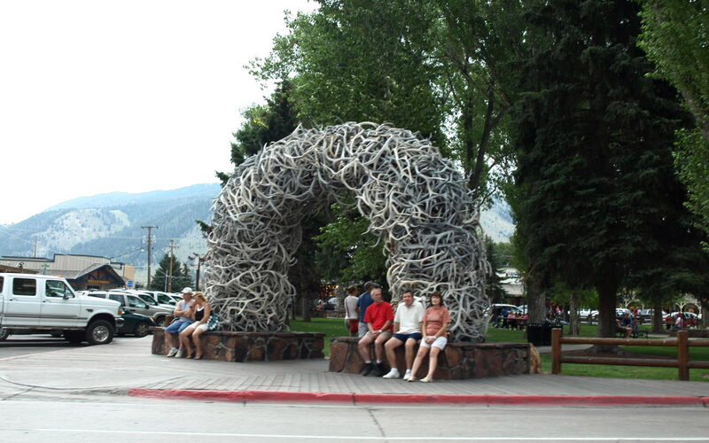 Jackson, Wyoming town square with elk antler arches and Teton Range