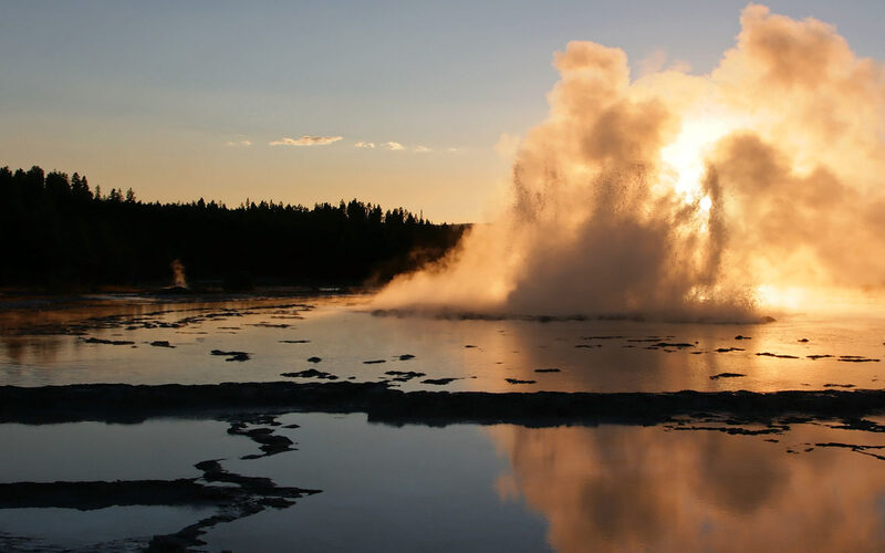 Geyser erupting at sunset in Yellowstone National Park, Wyoming